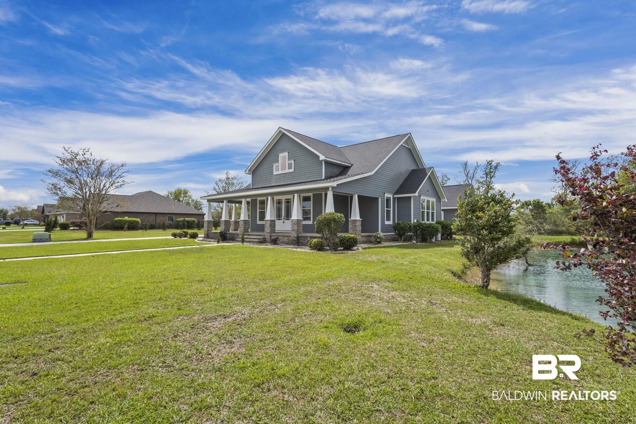 7059 Rocky Rd Loop Gulf Shores, AL 36542 - Photo 4 of 46 Farmhouse featuring a front lawn and a porch