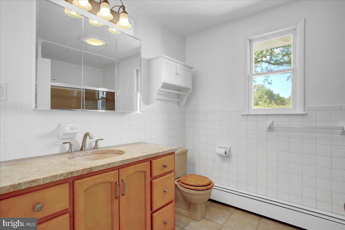 233 Hetrick Road Bernville, PA 19506 - Photo 19 of 29 a bathroom with a granite countertop sink a toilet and mirror