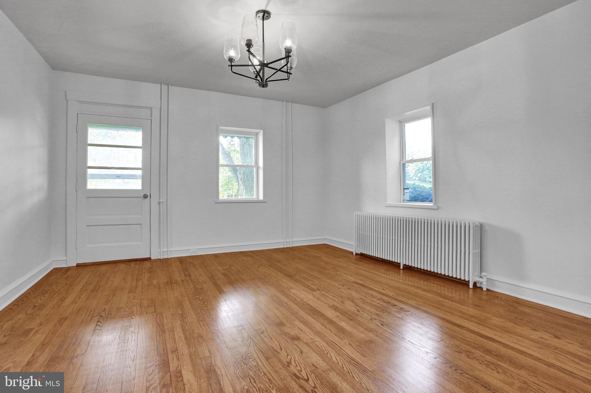 233 Hetrick Road Bernville, PA 19506 - Photo 26 of 29 an empty room with wooden floor chandelier and windows
