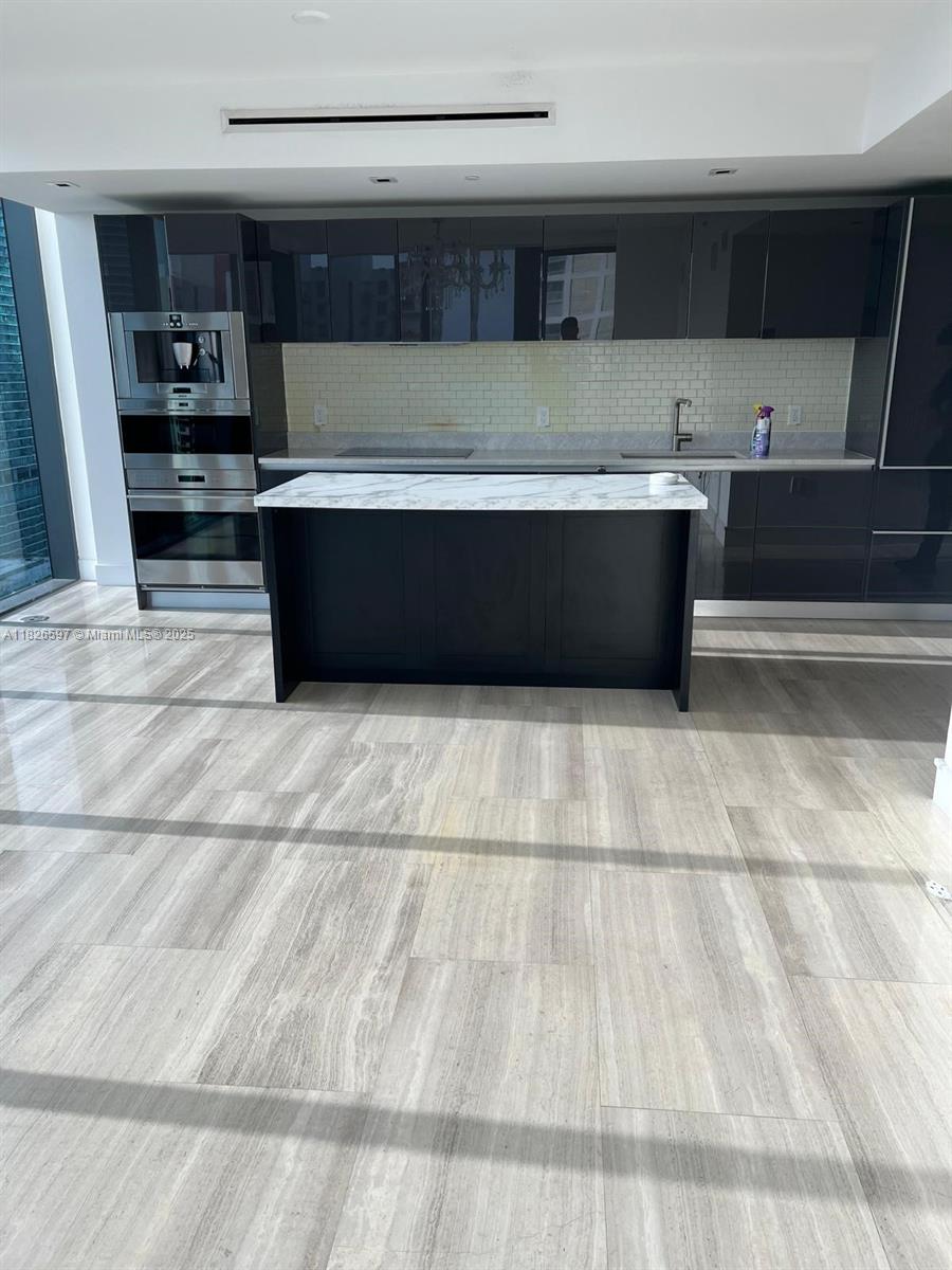 Brickell Miami, FL 33131 - Photo 14 of 23 a view of kitchen with cabinets and wooden floor