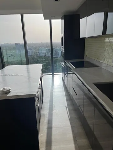 a view of a kitchen with a sink and wooden floor