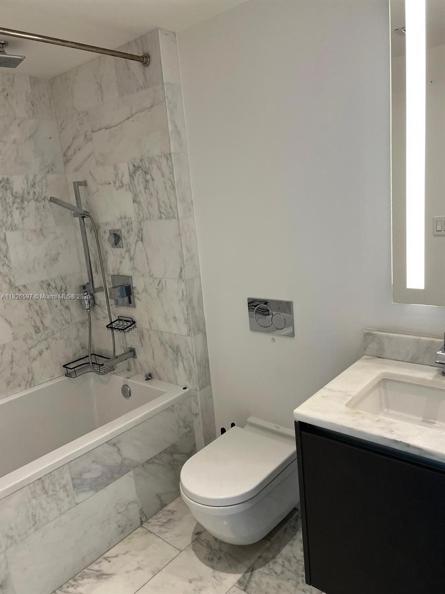 Brickell Miami, FL 33131 - Photo 19 of 23 a bathroom with a sink toilet and shower