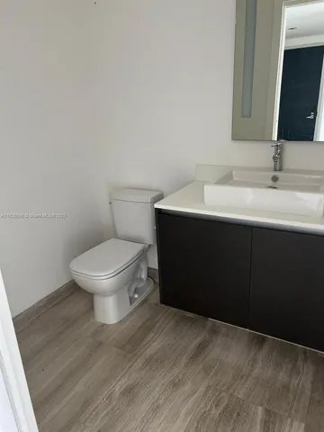 a bathroom with a sink toilet and mirror