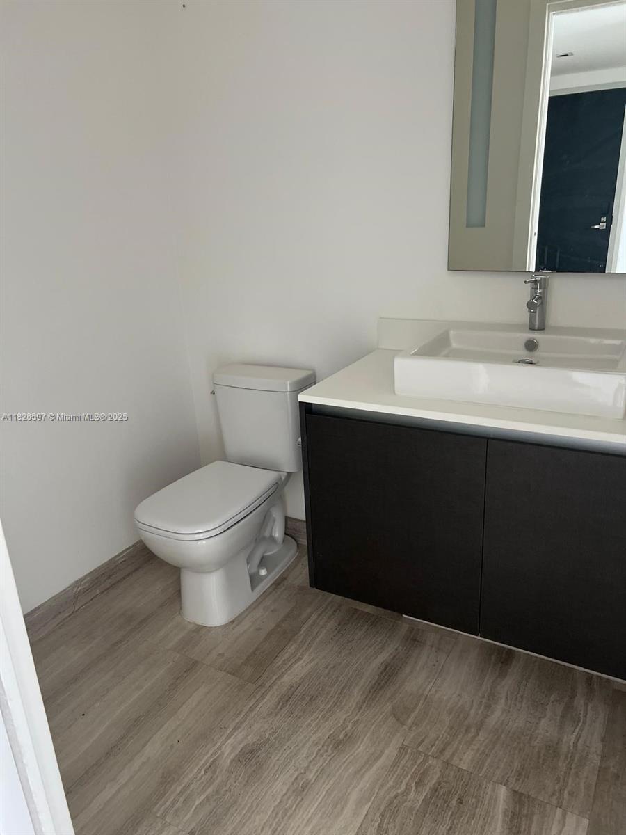 Brickell Miami, FL 33131 - Photo 20 of 23 a bathroom with a sink toilet and mirror