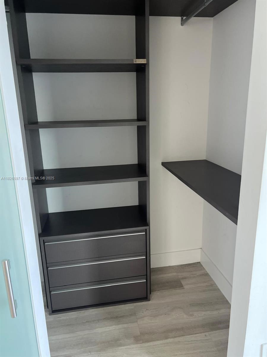 Brickell Miami, FL 33131 - Photo 22 of 23 a view of walk in closet with empty racks