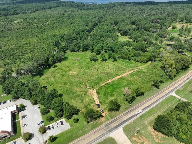 a view of a garden with a building in the background