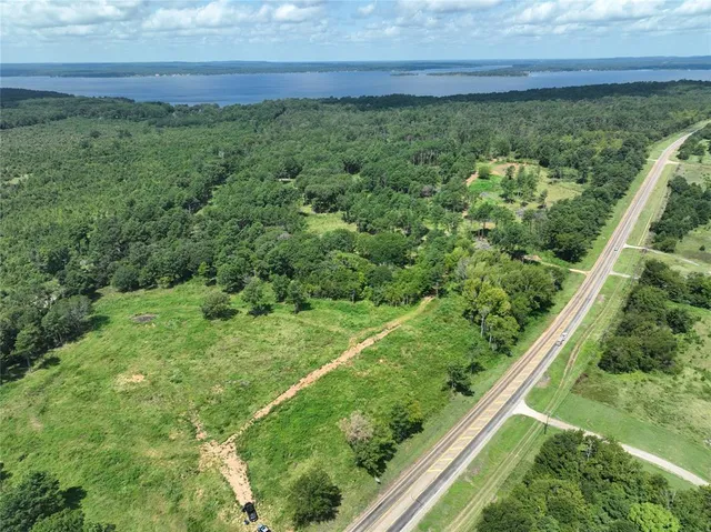 a view of a yard with a wooden fence