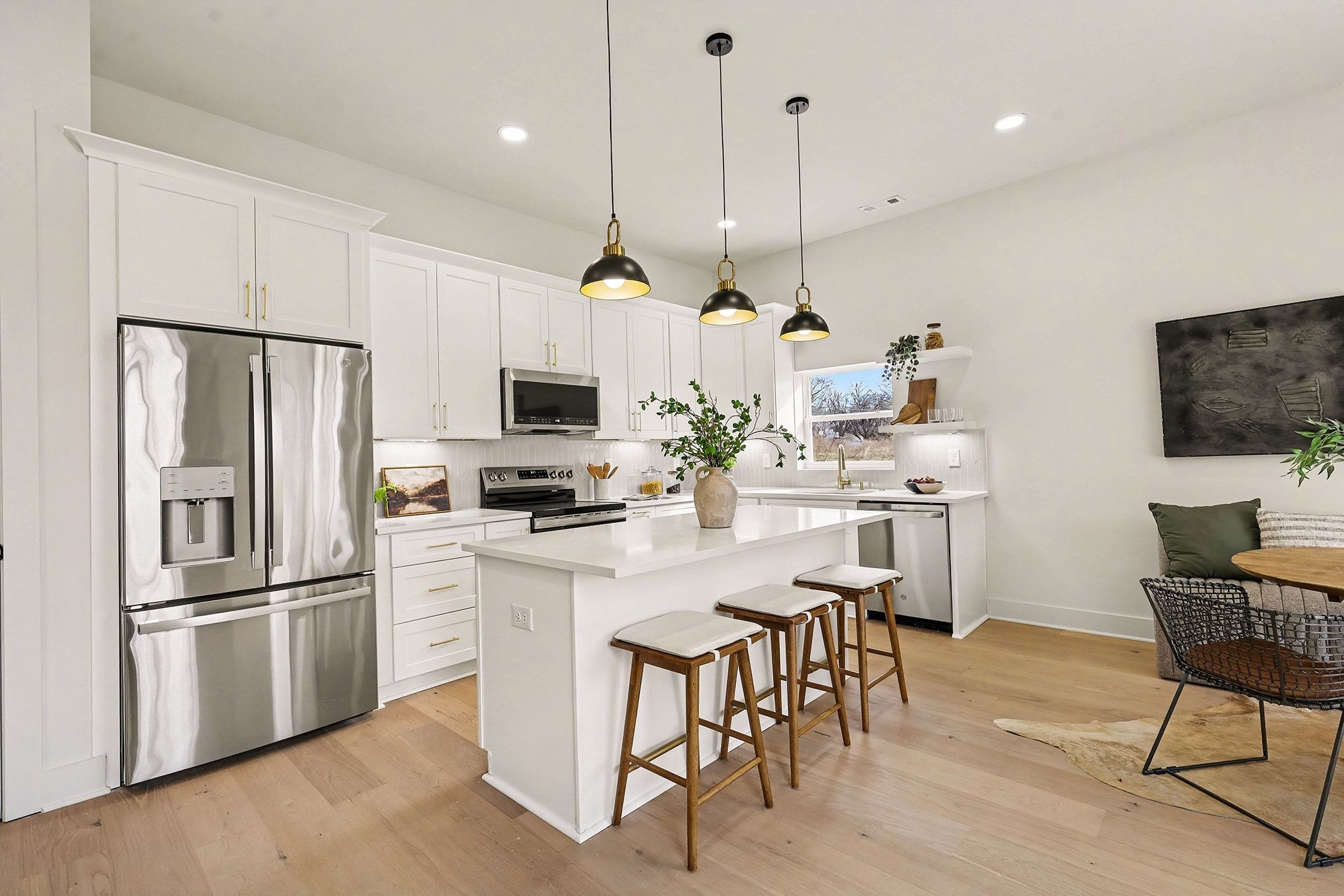 3411 Hydes Ferry Road Nashville, TN 37218 - Photo 6 of 23 a kitchen with stainless steel appliances granite countertop a refrigerator a stove a sink dishwasher a refrigerator with a dining table and chairs with wooden floor
