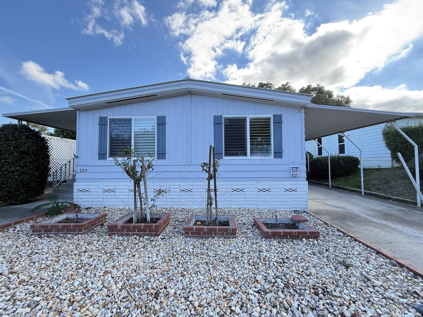 a front view of a house with garden
