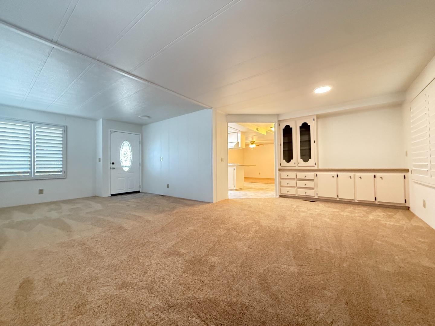 224 Queens Way, Unit 224 Pittsburg, CA 94565 - Photo 12 of 33 a view of an empty room with a window and a kitchen
