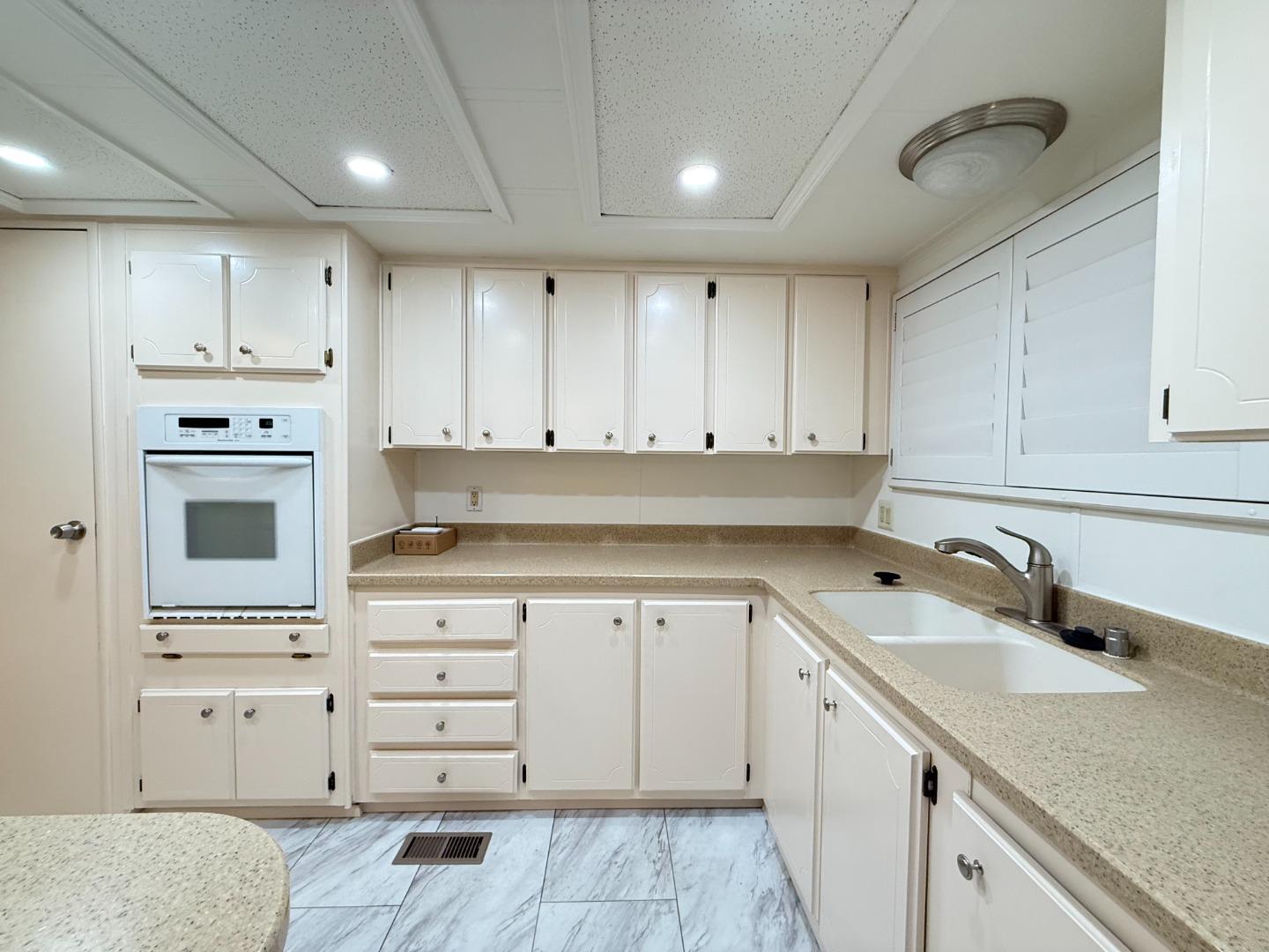 224 Queens Way, Unit 224 Pittsburg, CA 94565 - Photo 17 of 33 a kitchen with cabinets appliances a sink and a counter top