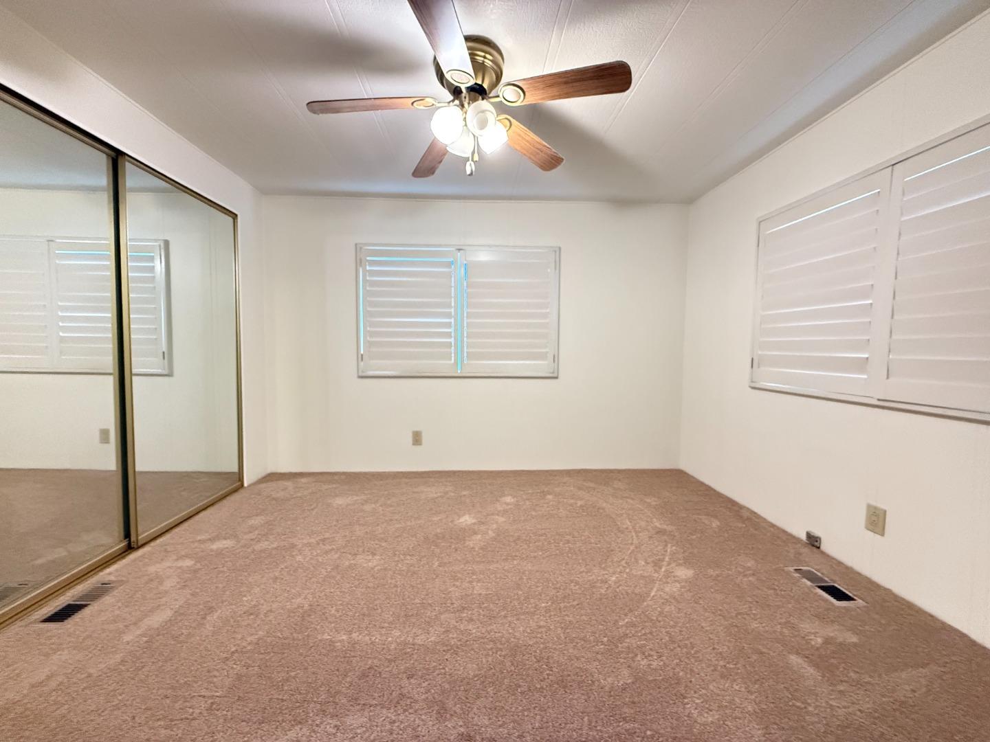 224 Queens Way, Unit 224 Pittsburg, CA 94565 - Photo 27 of 33 an empty room with windows and fan