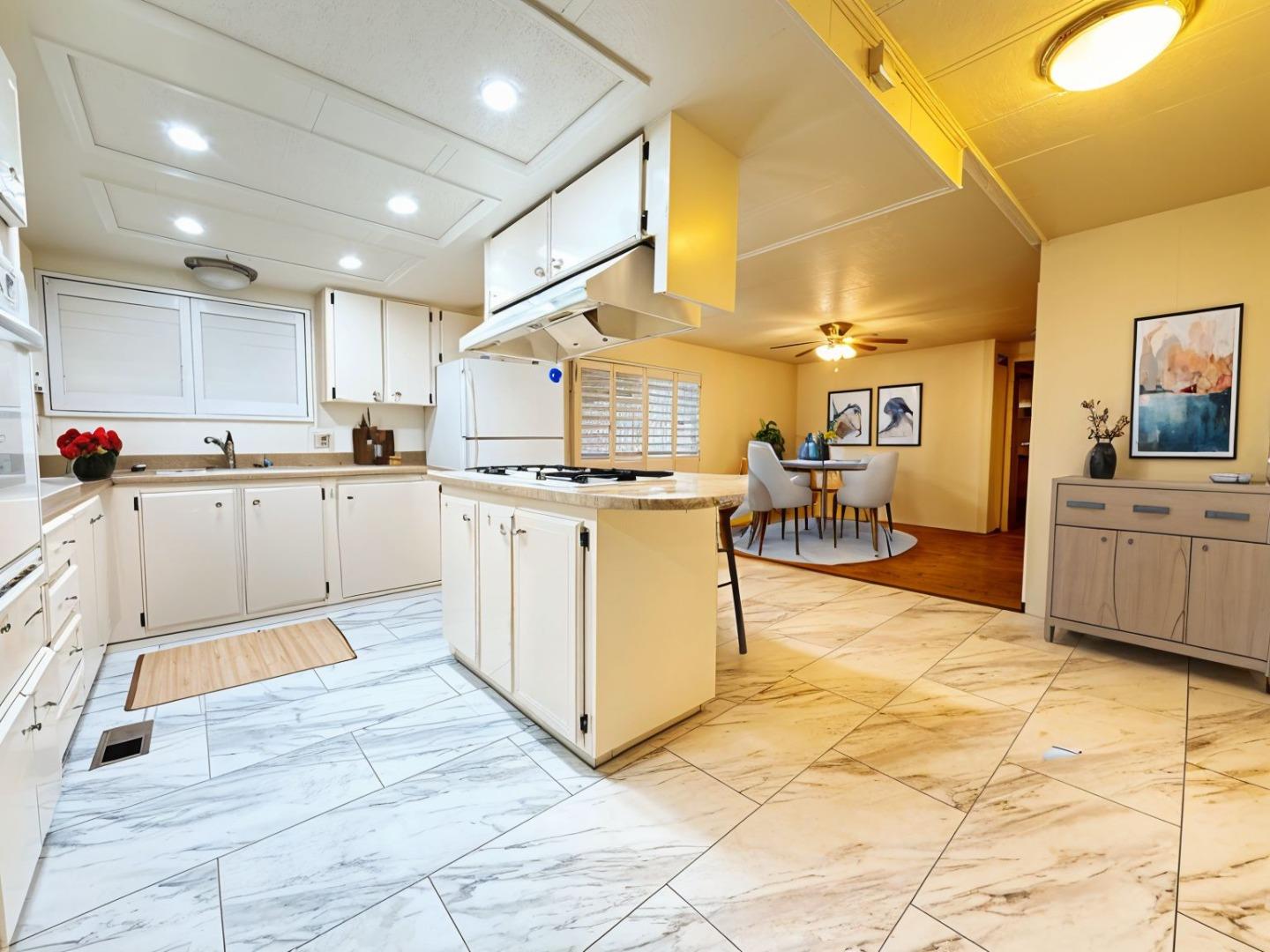 224 Queens Way, Unit 224 Pittsburg, CA 94565 - Photo 8 of 33 a kitchen with stainless steel appliances kitchen island granite countertop a sink and cabinets