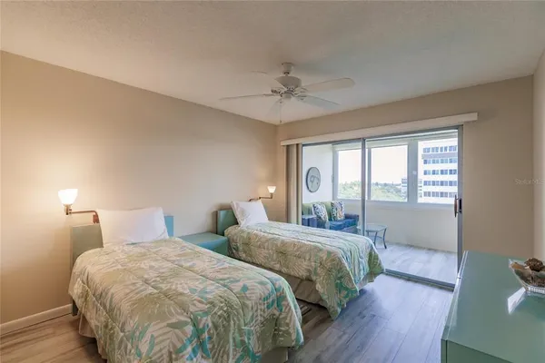 a bedroom with two beds and a chandelier