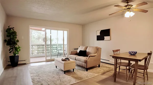 a living room with furniture and a floor to ceiling window