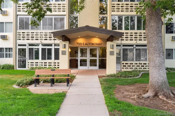 a front view of a residential apartment building with a yard