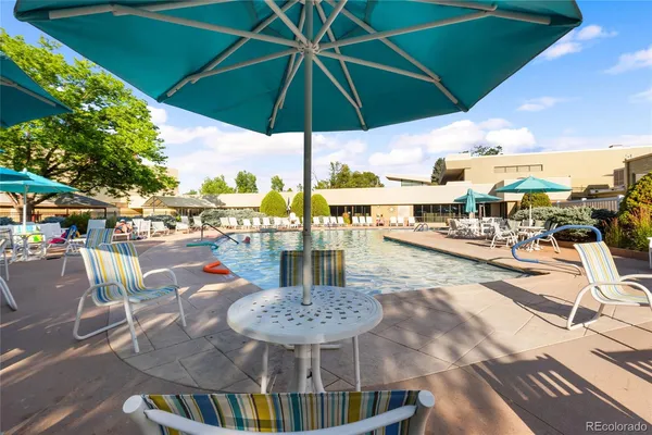 a view of a swimming pool with outdoor seating