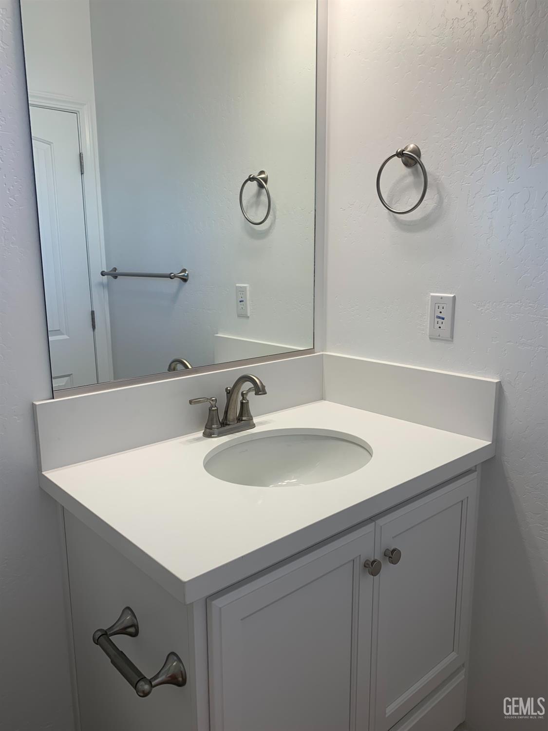Undisclosed Address Bakersfield, CA 93314 - Photo 13 of 14 a bathroom with a sink and a mirror