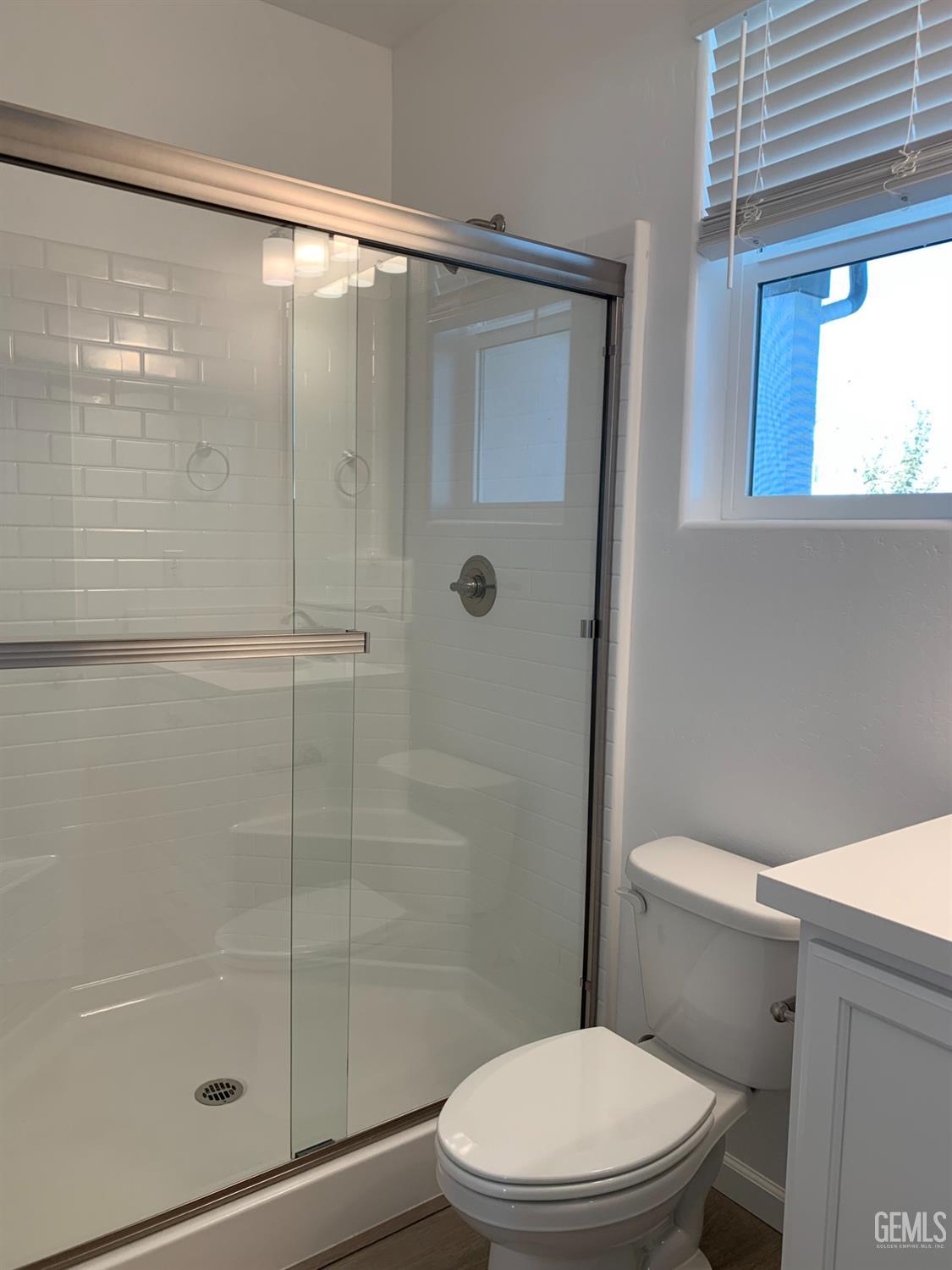 Undisclosed Address Bakersfield, CA 93314 - Photo 14 of 14 a white toilet next to a bathroom