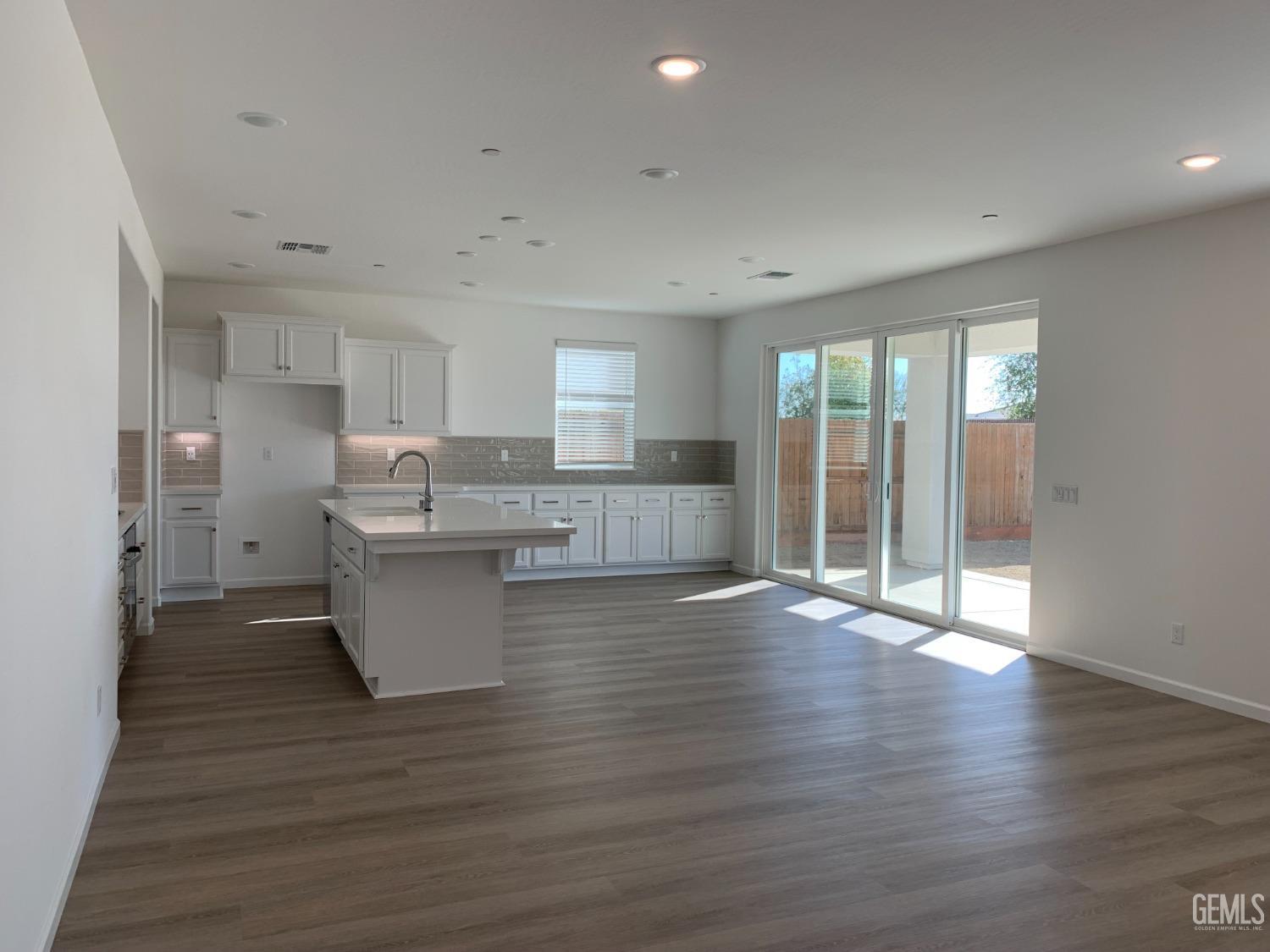 Undisclosed Address Bakersfield, CA 93314 - Photo 3 of 14 a view of kitchen with wooden floor and electronic appliances
