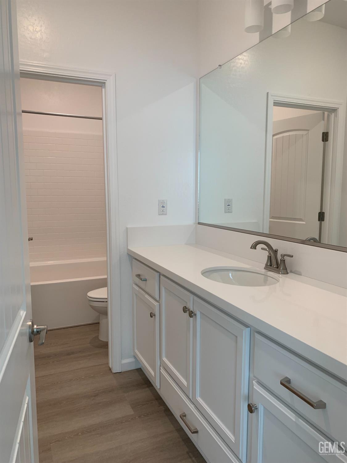 Undisclosed Address Bakersfield, CA 93314 - Photo 9 of 14 a bathroom with a granite countertop sink toilet and shower