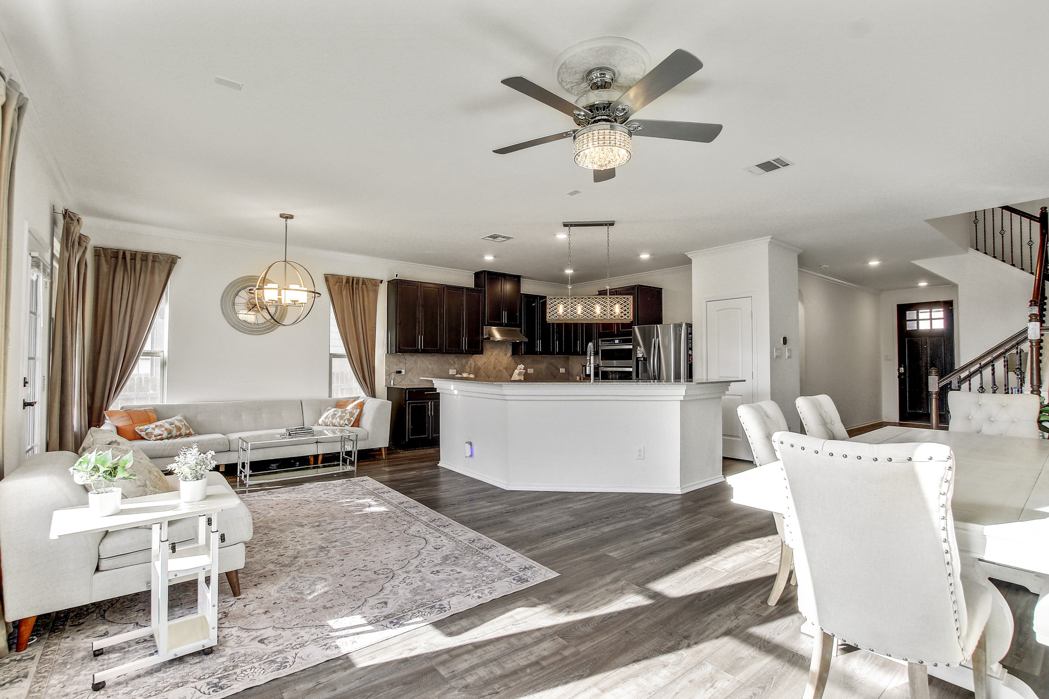 205 Travers Stake Trail Elgin, TX 78621 - Photo 11 of 28 Dining space with a chandelier, healthy amount of natural light, ceiling fan, dark wood-style flooring, and ornamental molding