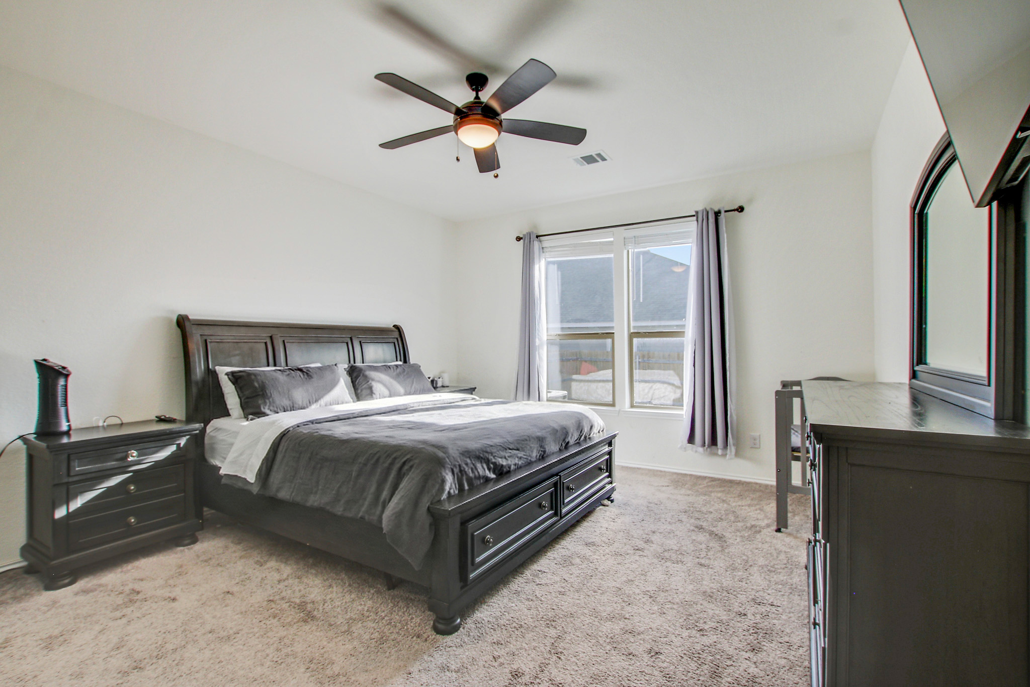 205 Travers Stake Trail Elgin, TX 78621 - Photo 14 of 28 Bedroom with light colored carpet and a ceiling fan