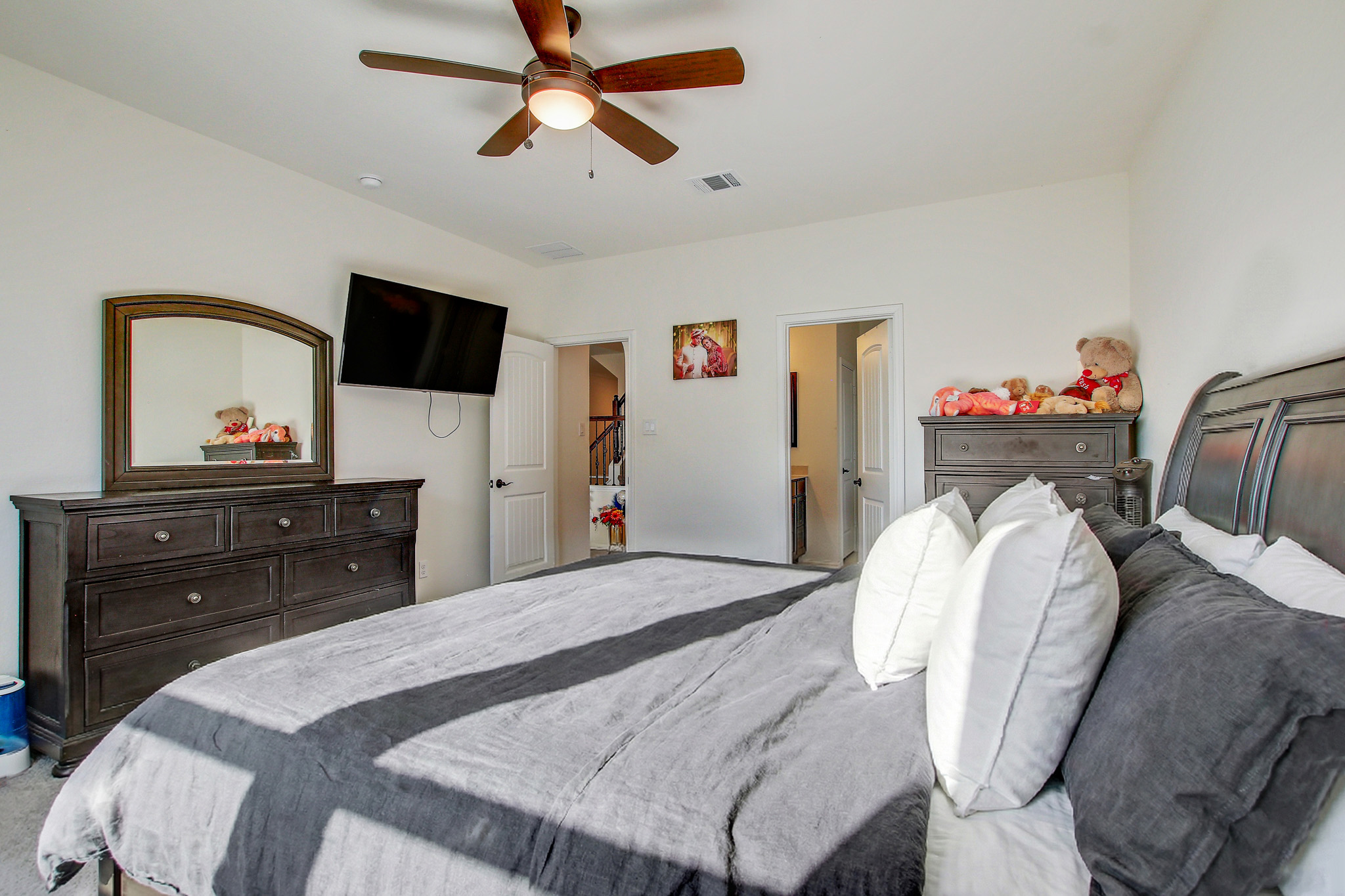 205 Travers Stake Trail Elgin, TX 78621 - Photo 15 of 28 Bedroom featuring a ceiling fan and carpet floors