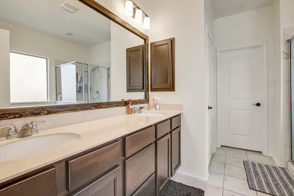 a bathroom with a sink double vanity and a mirror