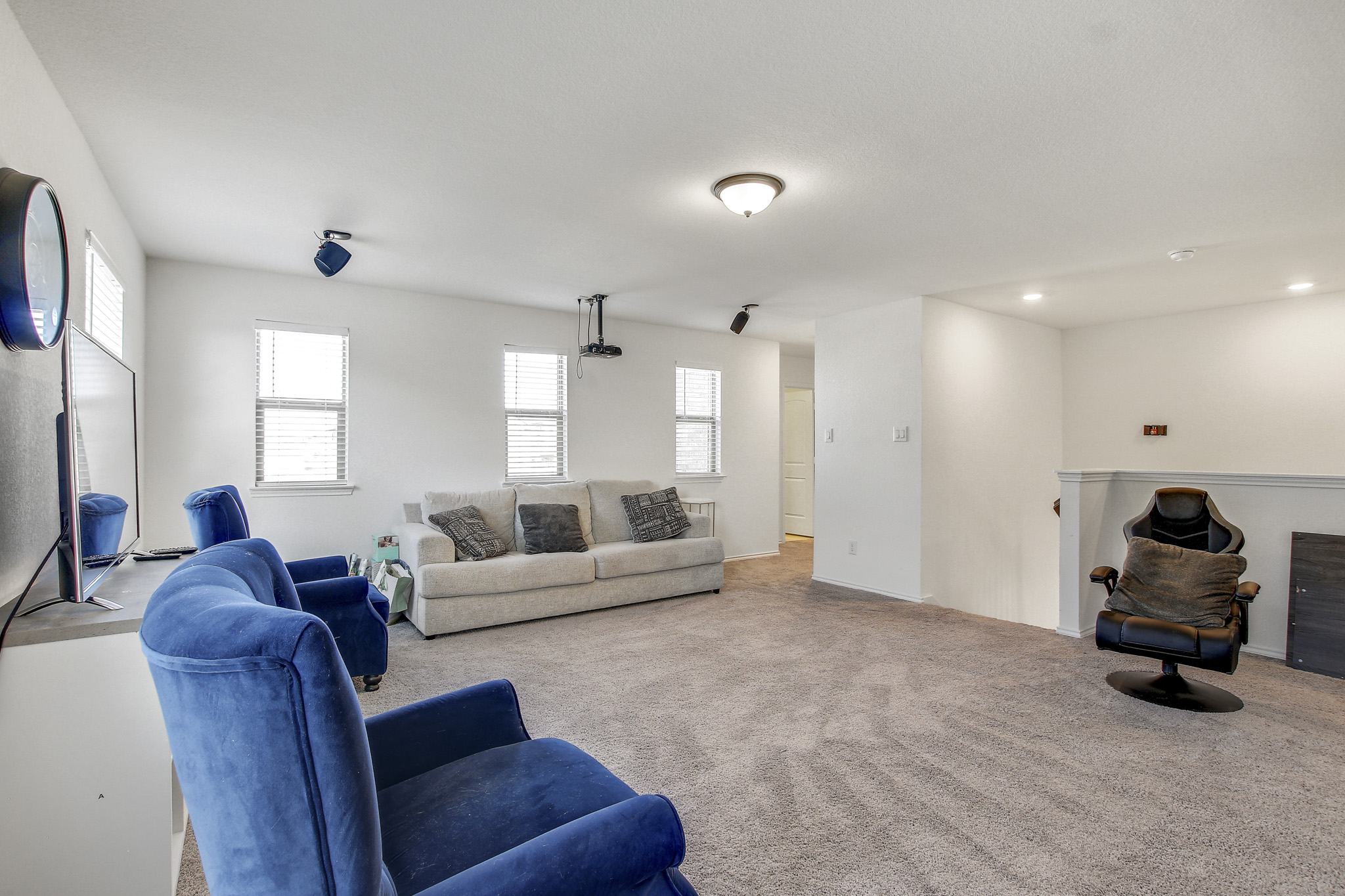 205 Travers Stake Trail Elgin, TX 78621 - Photo 18 of 28 Carpeted living area with recessed lighting