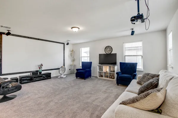 a living room with furniture gym equipment and a window