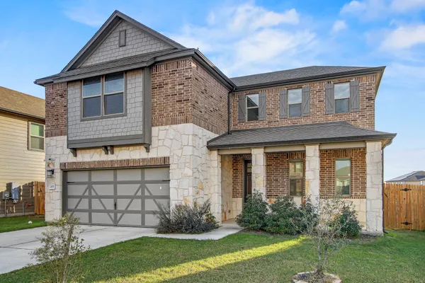 a front view of a house with a yard