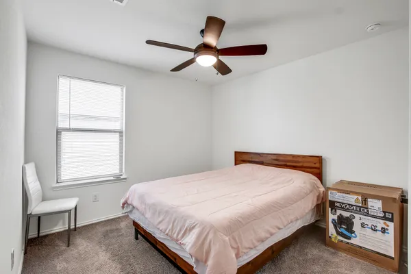 a bedroom with a bed and a window