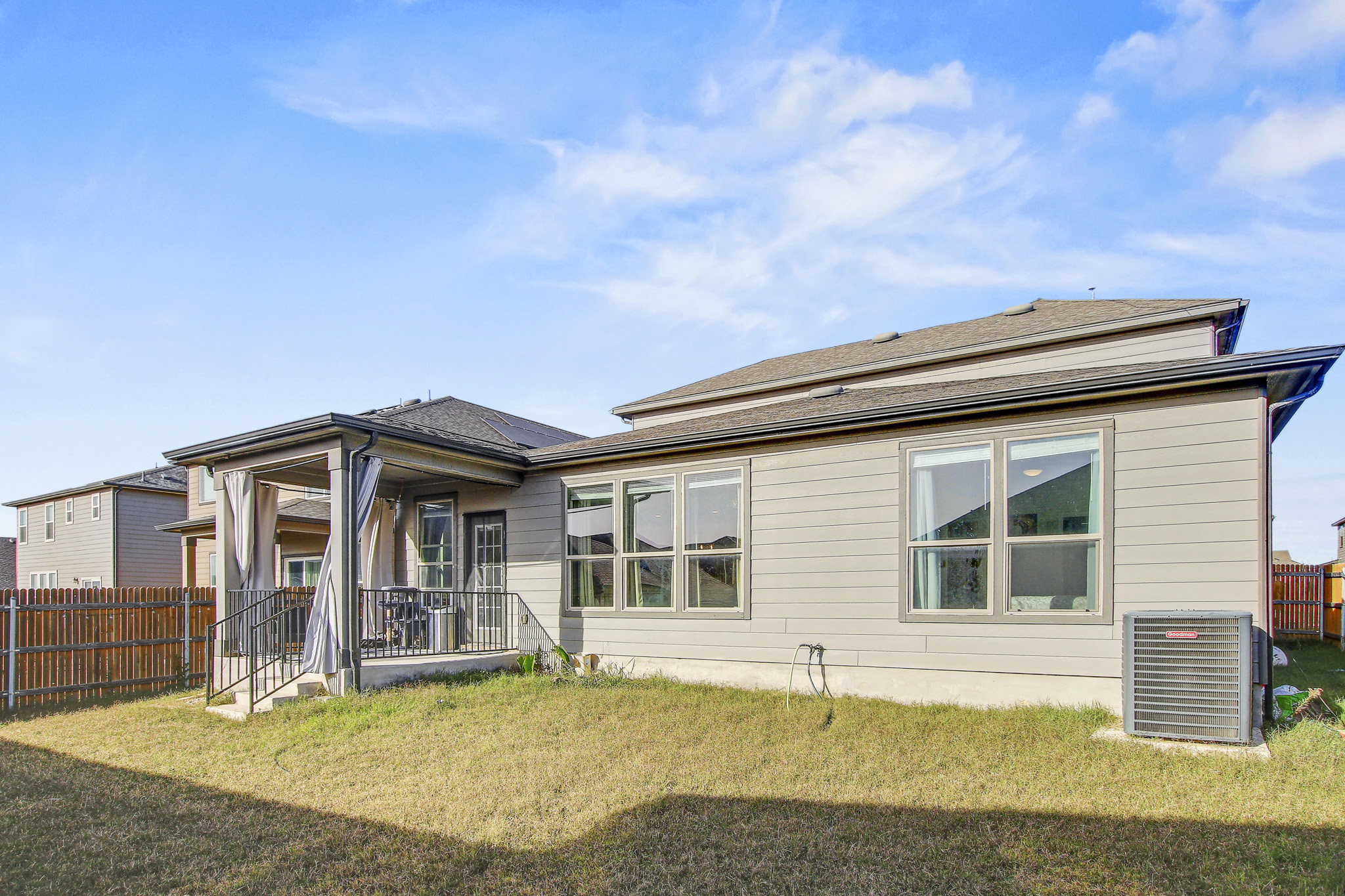 205 Travers Stake Trail Elgin, TX 78621 - Photo 28 of 28 Back of property with a patio and a shingled roof
