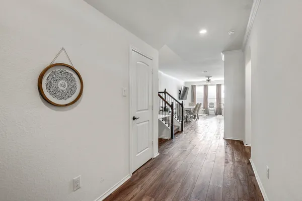 a view of a hallway with wooden floor