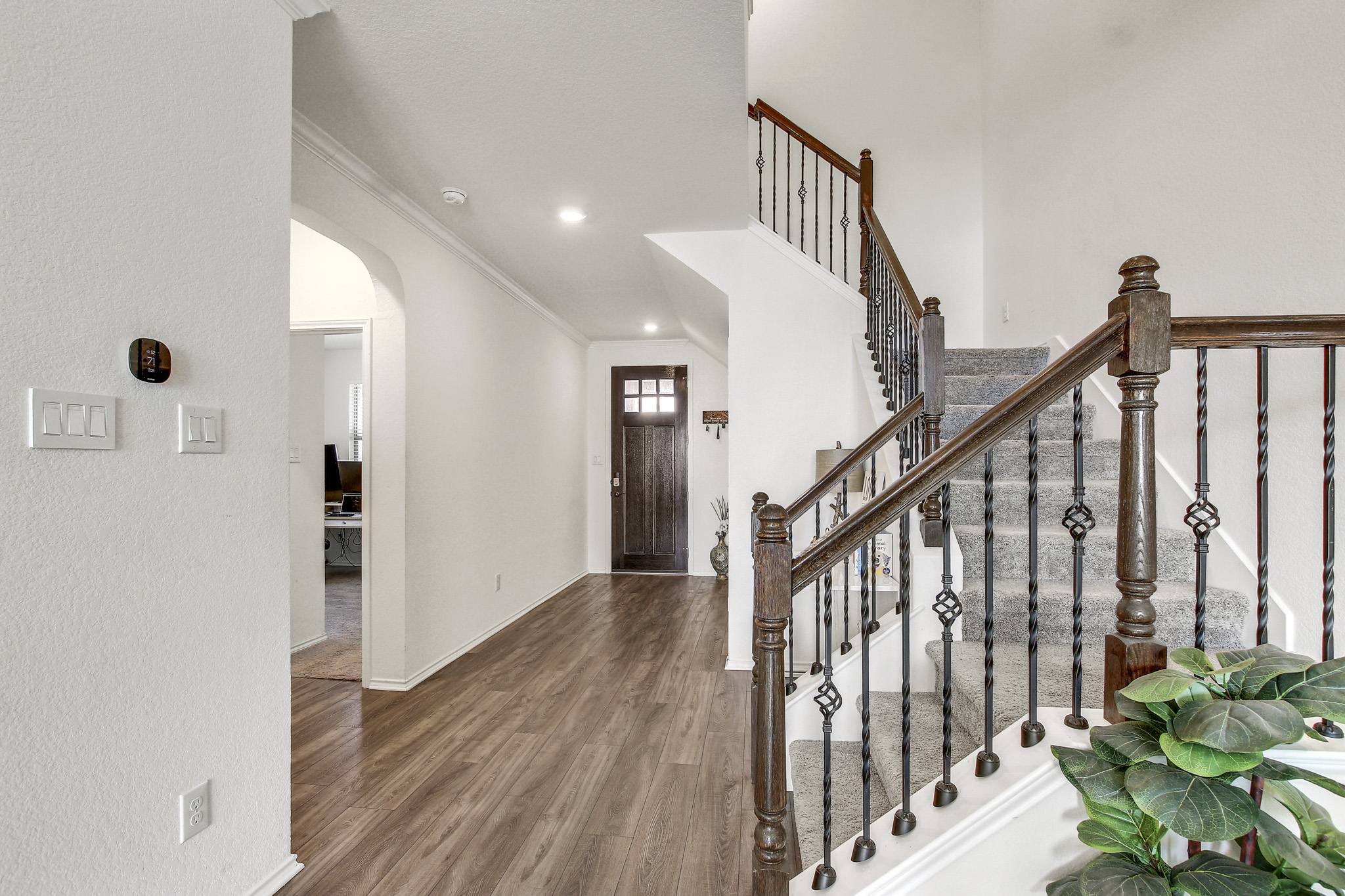 205 Travers Stake Trail Elgin, TX 78621 - Photo 6 of 28 Entryway with arched walkways, dark wood finished floors, ornamental molding, recessed lighting, and a textured wall