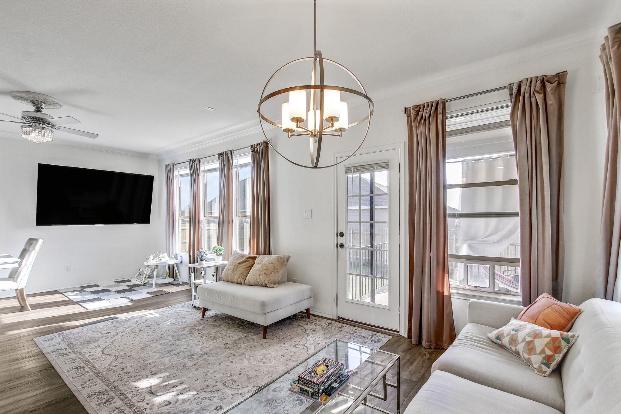 205 Travers Stake Trail Elgin, TX 78621 - Photo 10 of 28 Living room featuring a ceiling fan, wood finished floors, and suspended lighting