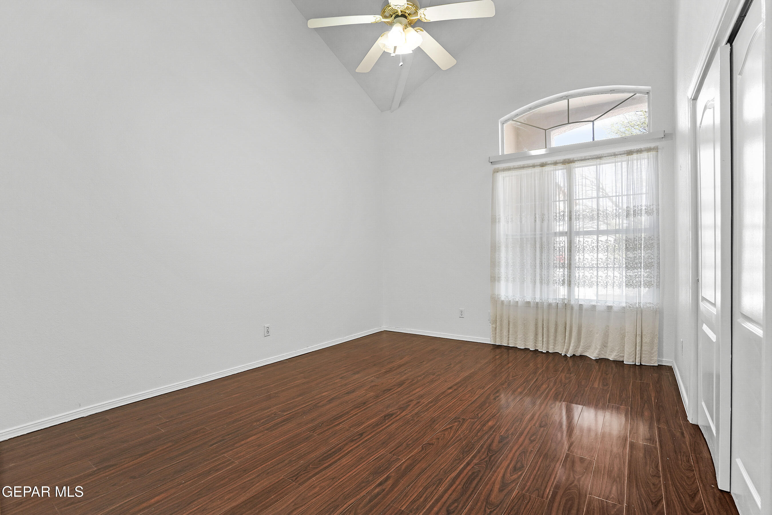 660 Rosinante Road El Paso, TX 79922 - Photo 20 of 43 an empty room with wooden floor fan and windows