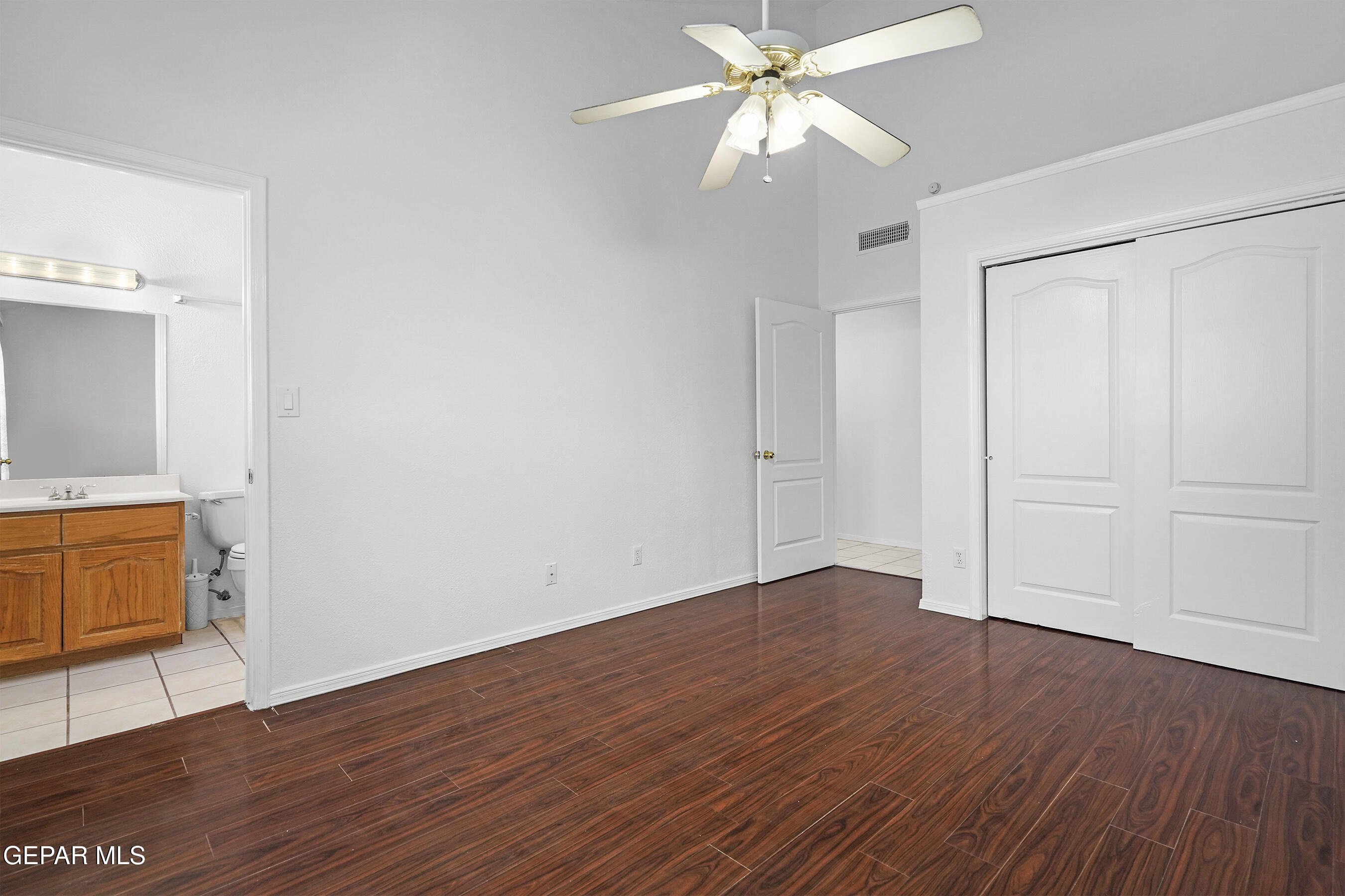 660 Rosinante Road El Paso, TX 79922 - Photo 23 of 43 an empty room with wooden floor and fan