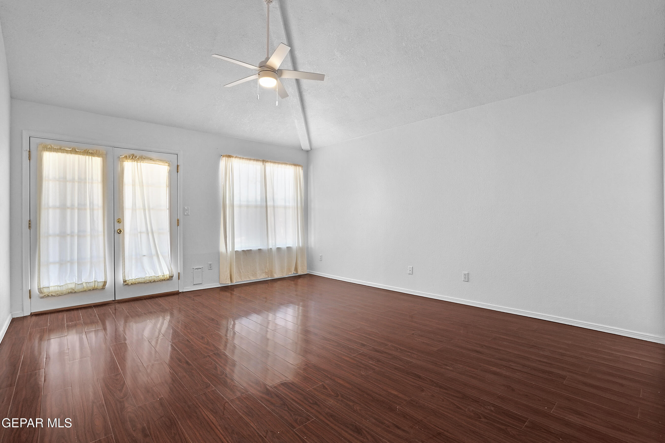 660 Rosinante Road El Paso, TX 79922 - Photo 28 of 43 a view of an empty room with wooden floor and a window