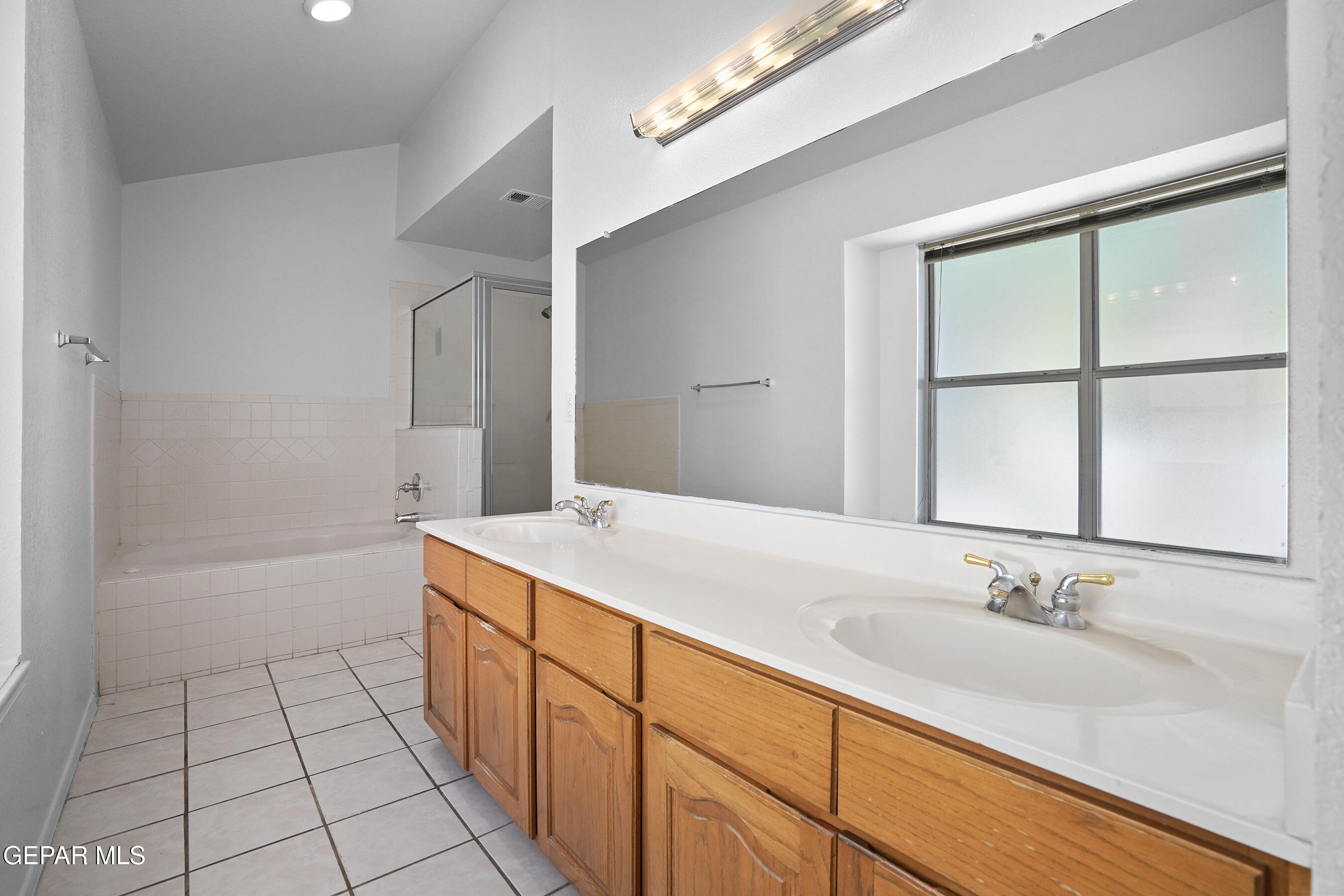 660 Rosinante Road El Paso, TX 79922 - Photo 31 of 43 a spacious bathroom with a granite countertop sink and a bathtub
