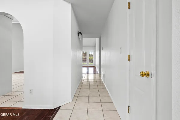 a kitchen with white cabinets and appliances