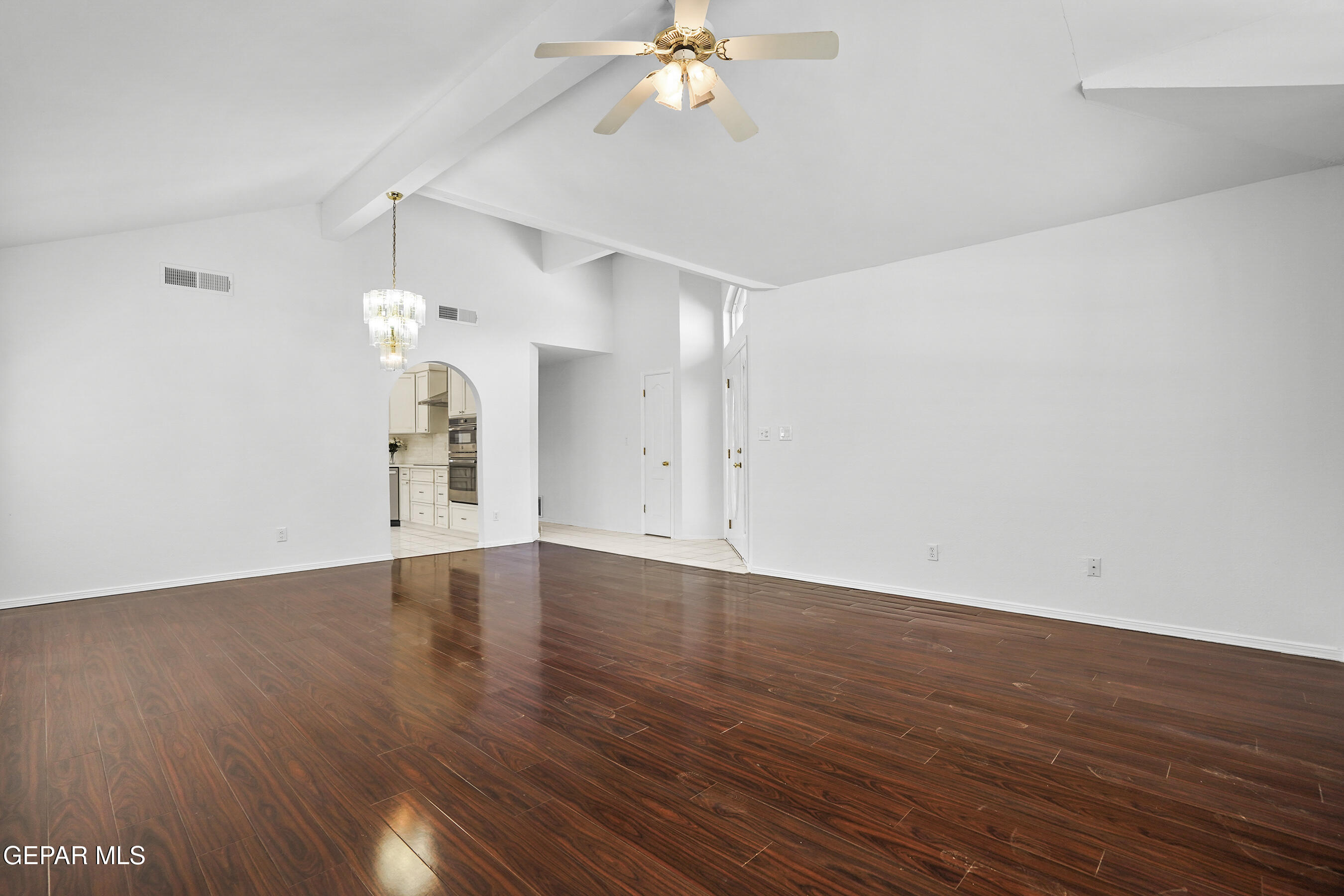 660 Rosinante Road El Paso, TX 79922 - Photo 10 of 43 a view of an empty room with wooden floor and a ceiling fan