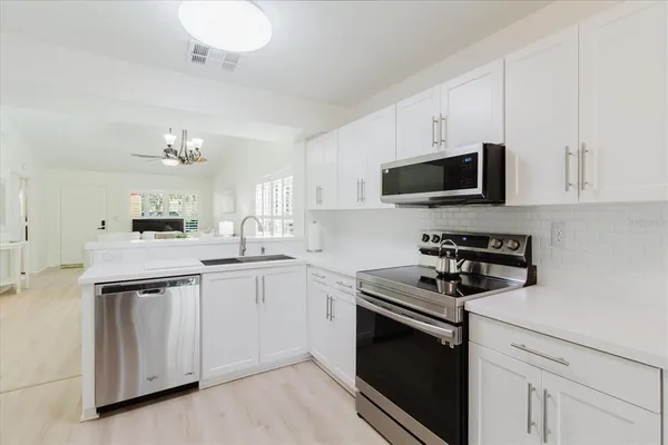 a kitchen with a sink stove and microwave