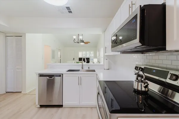 a kitchen with a sink cabinets and appliances