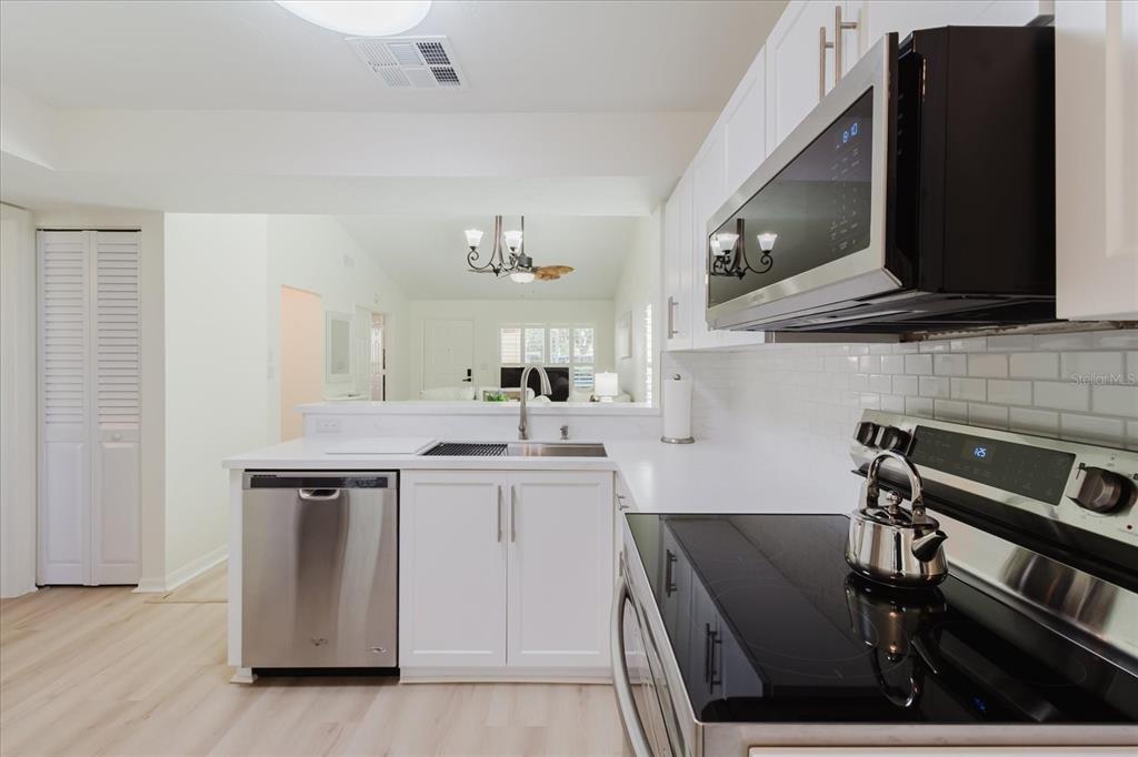 7807 Hardwick Drive, Unit 111 New Port Richey, FL 34653 - Photo 16 of 38 a kitchen with a sink cabinets and appliances