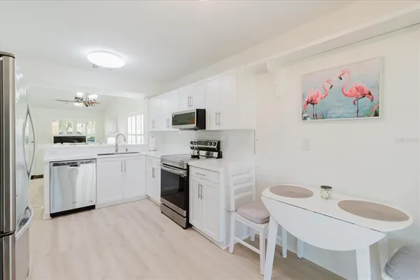 a kitchen with a sink cabinets and wooden floor