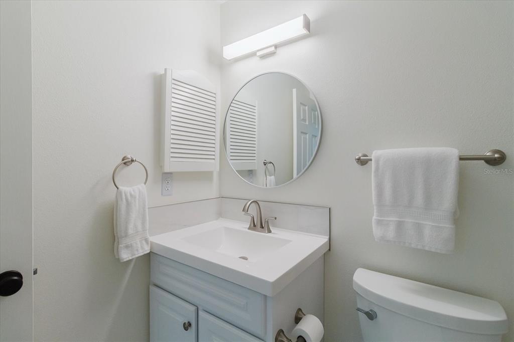 7807 Hardwick Drive, Unit 111 New Port Richey, FL 34653 - Photo 24 of 38 a bathroom with a sink a toilet and a mirror