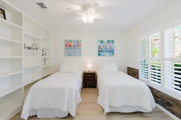 a bedroom with a large bed and a chandelier