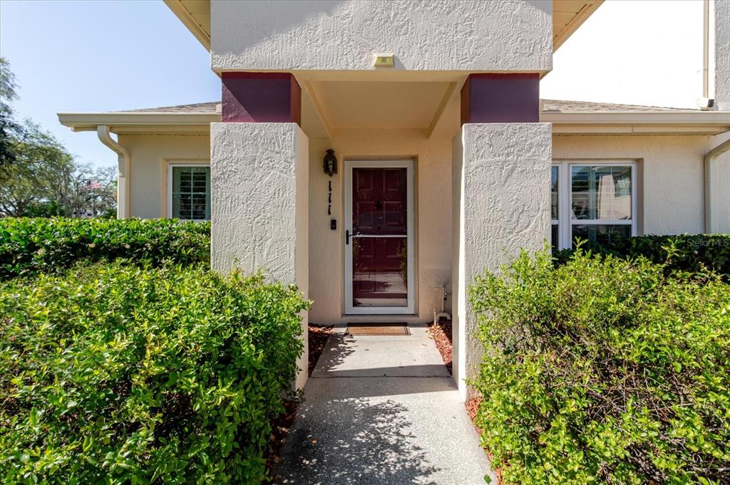 7807 Hardwick Drive, Unit 111 New Port Richey, FL 34653 - Photo 3 of 38 a front view of a house with a yard